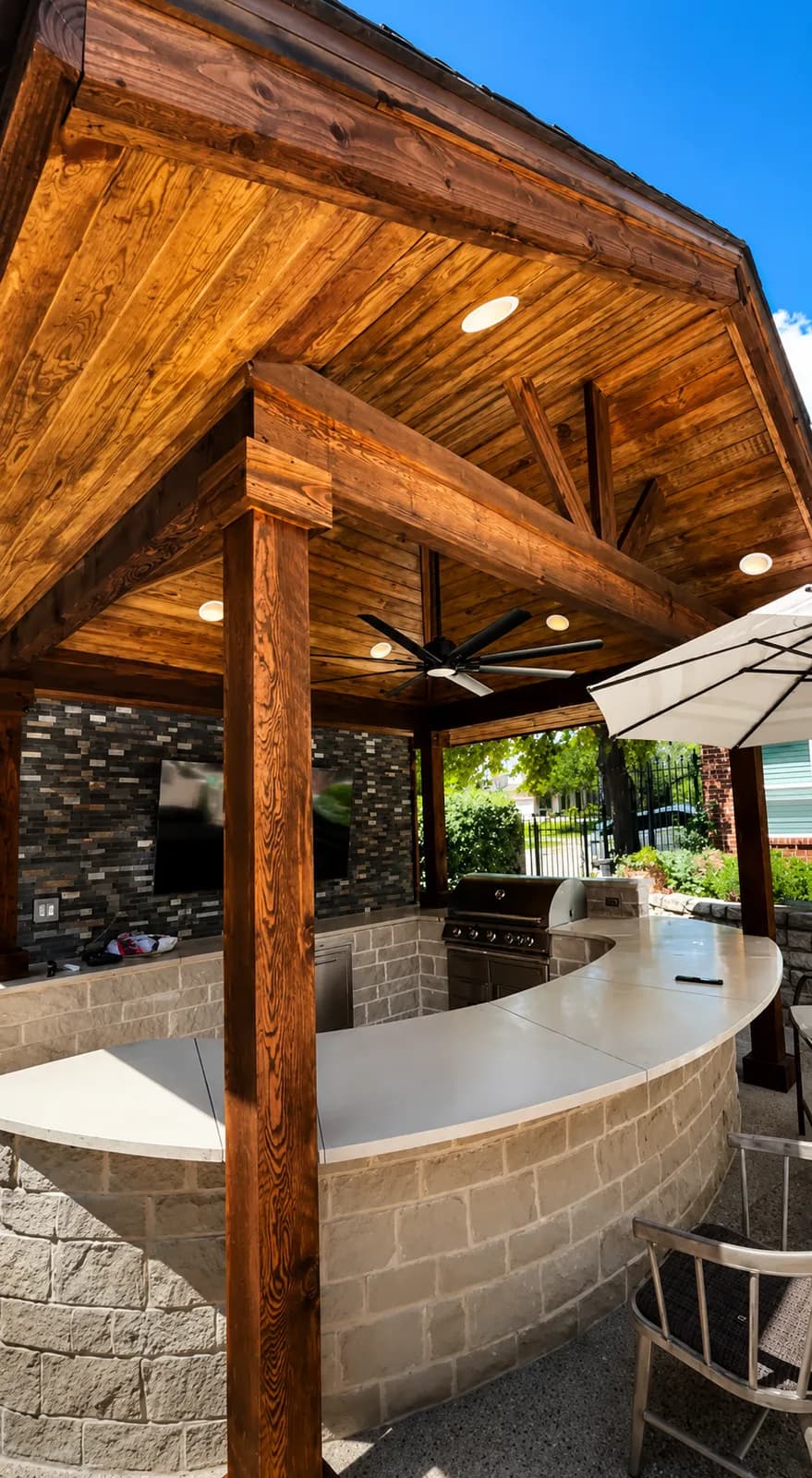 Cedar patio cover over a backyard in a master-planned Frisco, TX community by i30 Builders