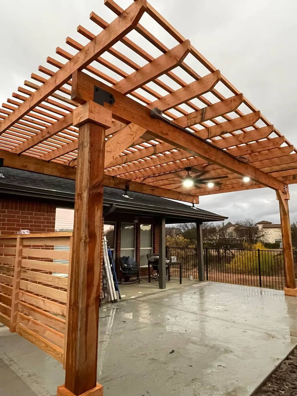 Open-slat Western Red Cedar pergola on 6x6 posts with knee braces.