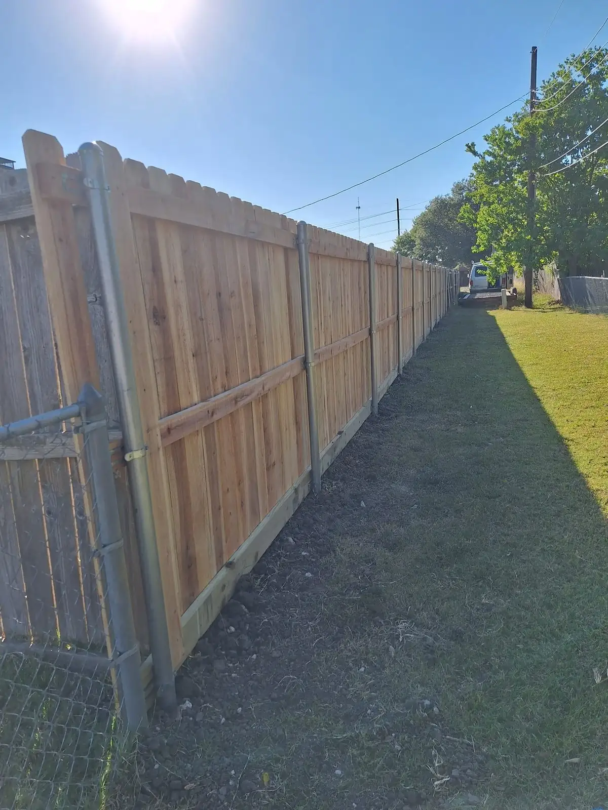 Cedar privacy fence set on galvanized steel posts.