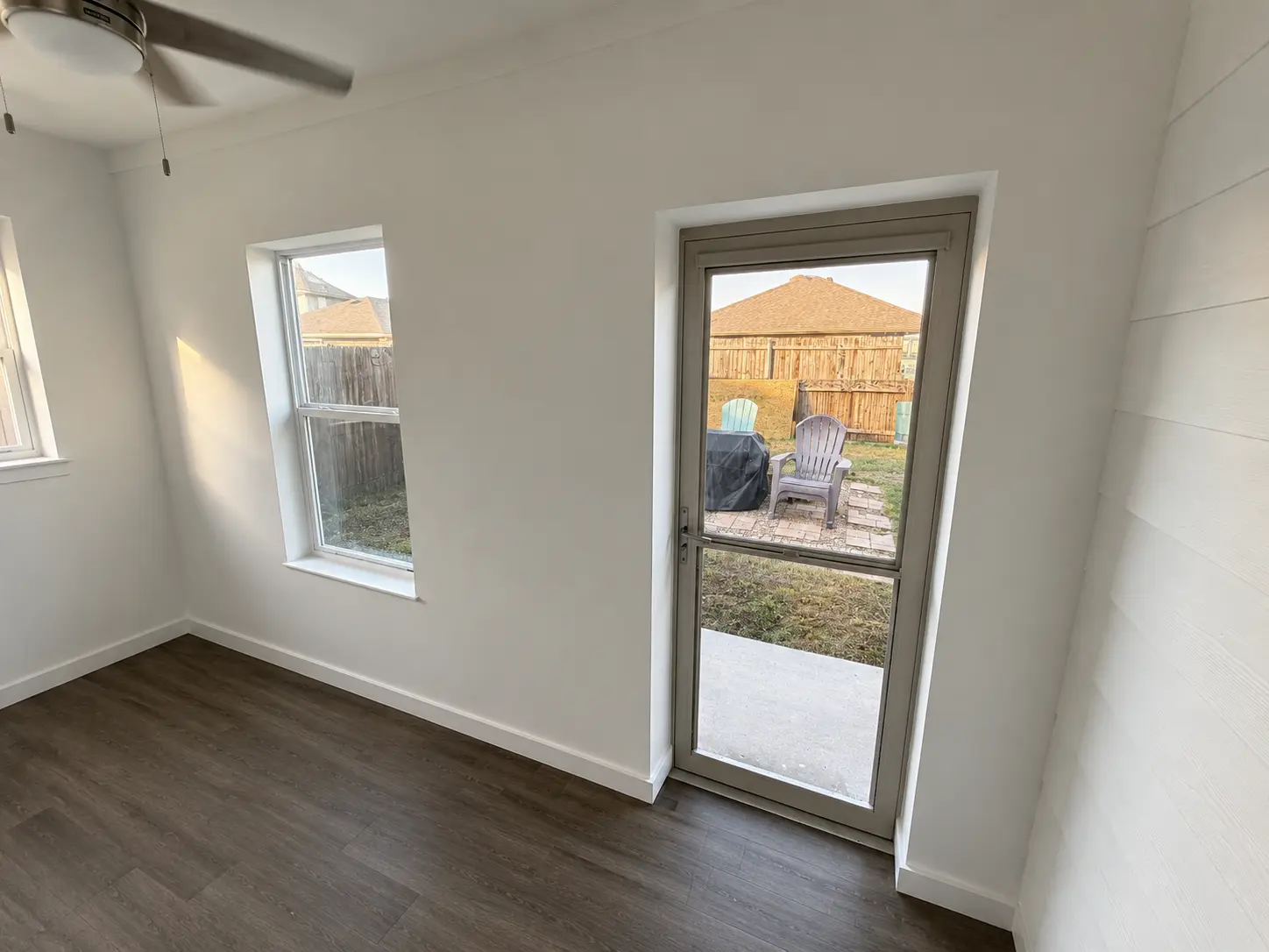 The same Crandall office: a new window and a full-glass door out to the yard.