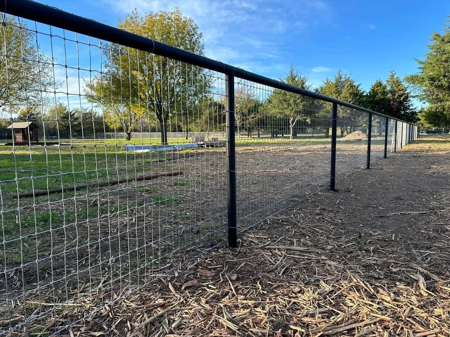 Pipe-top field fence with welded wire on steel posts.