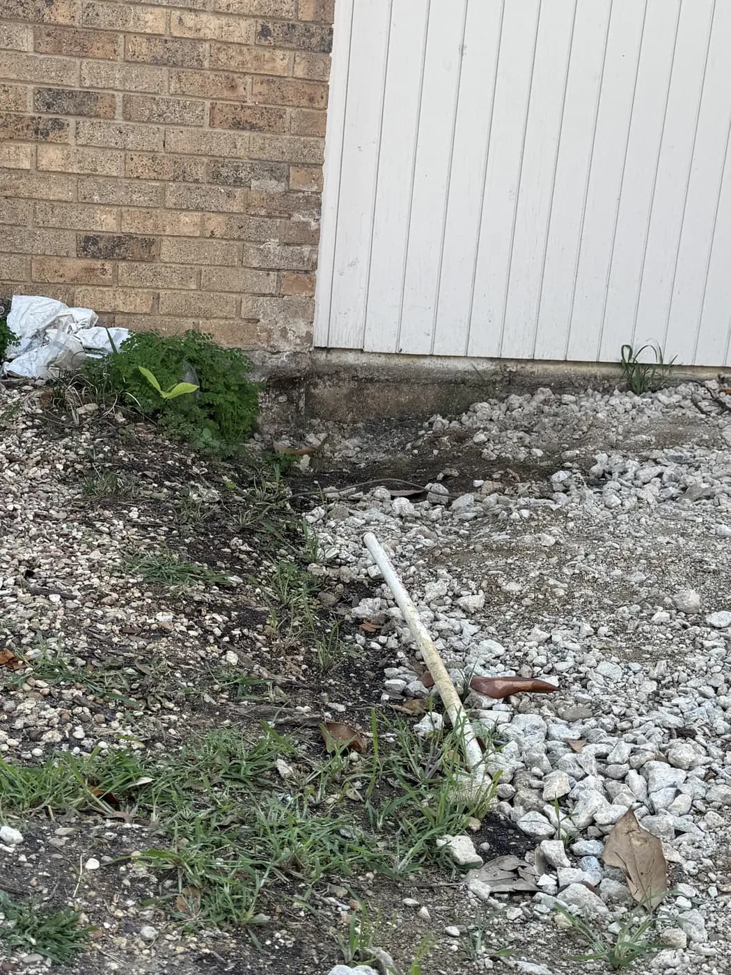 Before: the existing gravel base at the foundation, re-graded and compacted rather than replaced.