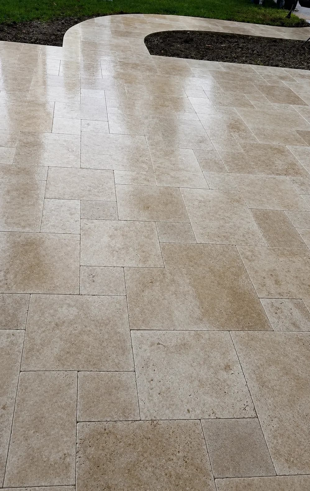 French-pattern travertine walkway meeting the courtyard.
